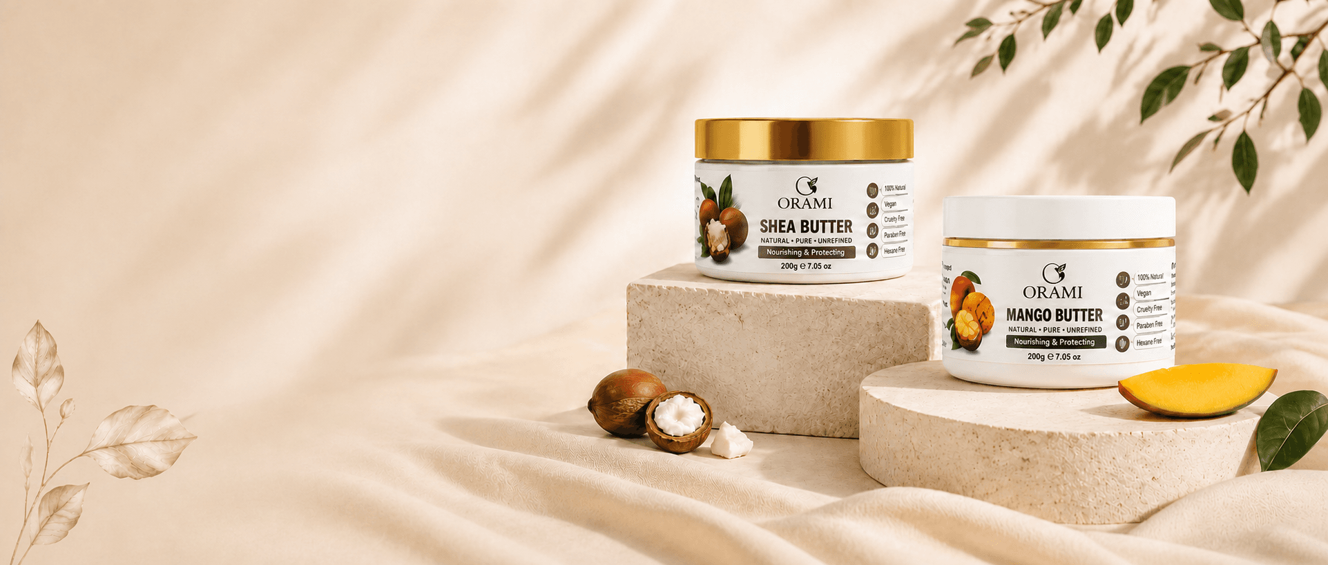 Orami pure shea and mango butters displayed on warm stone plinths